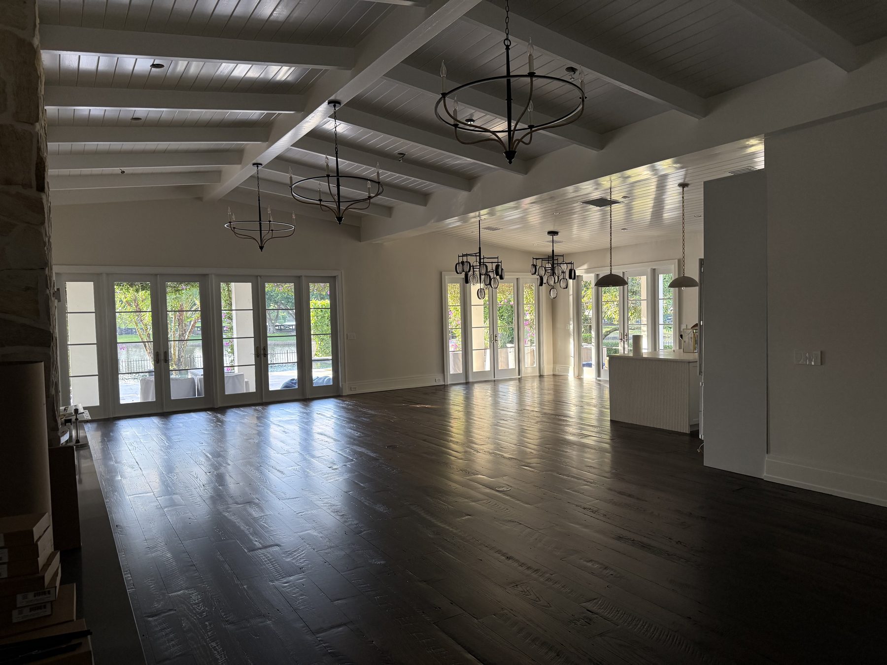 Finished great room with beamed ceiling and French doors
